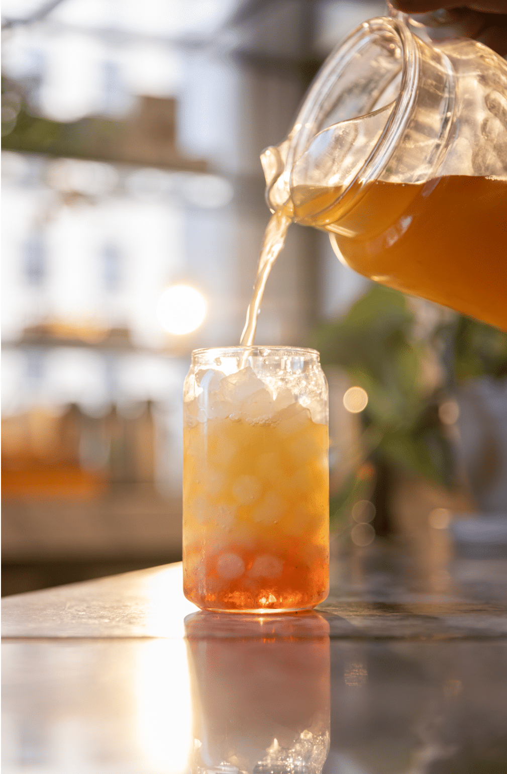 Iced tea being poured into a glass cup