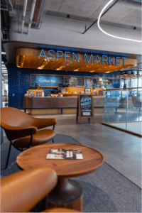 Aspen Market Coffee Bar with a blue backsplash and wooden table in front