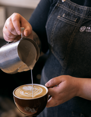 Barista pouring latte art, coffee latte art, cafe barista training