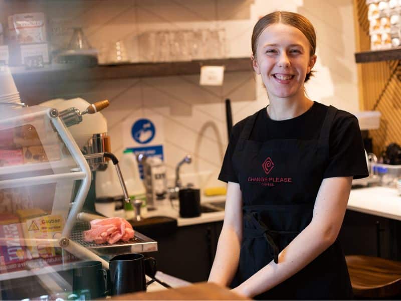 Female change please barista behind the counter smiling