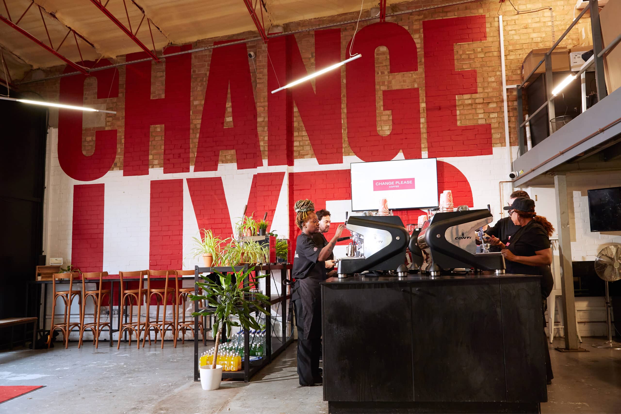 Change Please baristas making coffee in a change please coffee shop