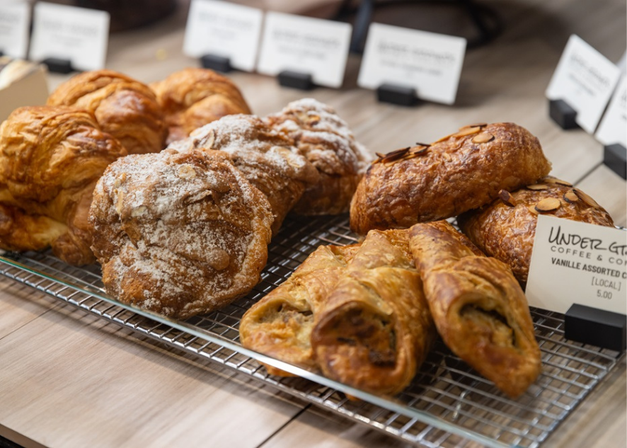 Pastries on a metal tray with label tags